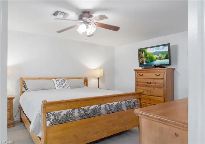 Carpeted bedroom with ceiling fan