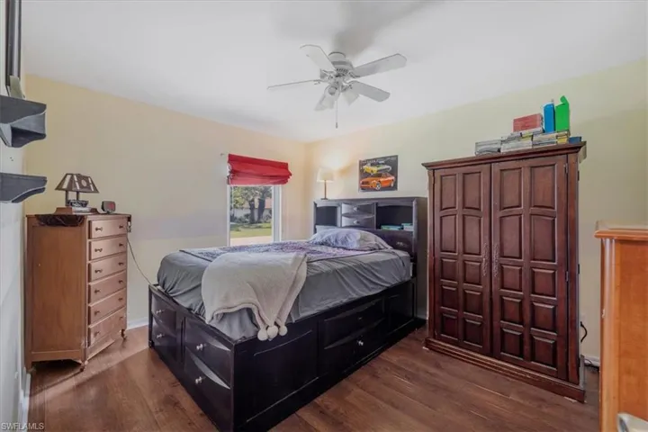 Bedroom featuring ceiling fan and dark hardwood / wood-style floors