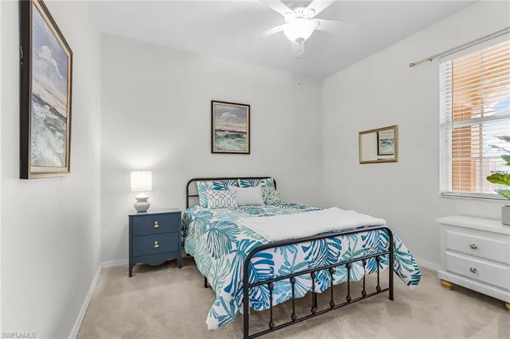 Bedroom with light carpet and ceiling fan