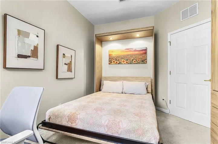 Bedroom with light carpet