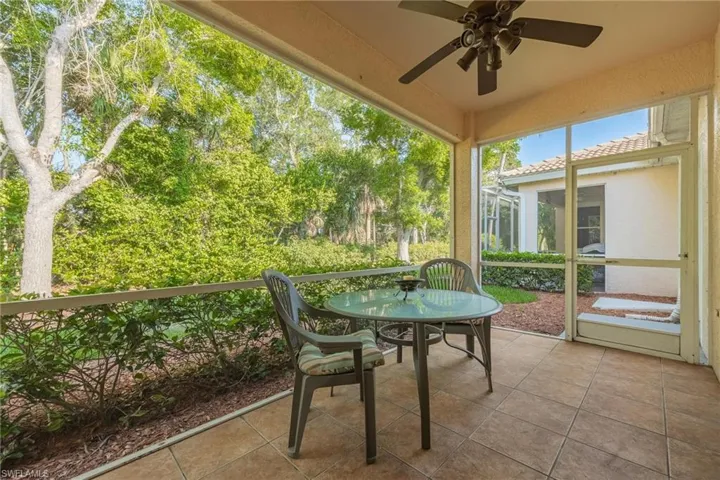 Unfurnished sunroom with ceiling fan