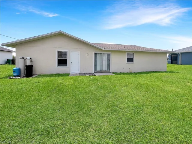 Back of property with a yard