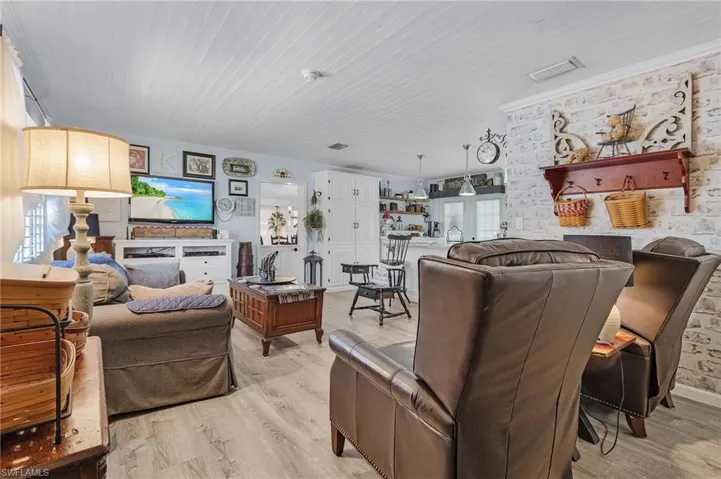 The ceiling is tongue and groove pine, giving the living room and kitchen a cozy, cottage feel.