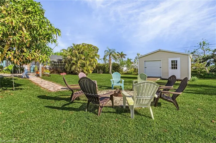 Enjoy the fire pit on cool Island nights.  There is a mango tree on the left!