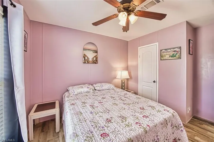 Bedroom with ceiling fan and wood finished floors