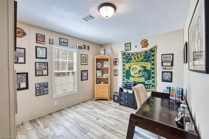 Office area with light wood-style floors
