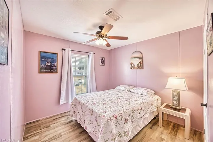Bedroom with ceiling fan and light wood-style floors