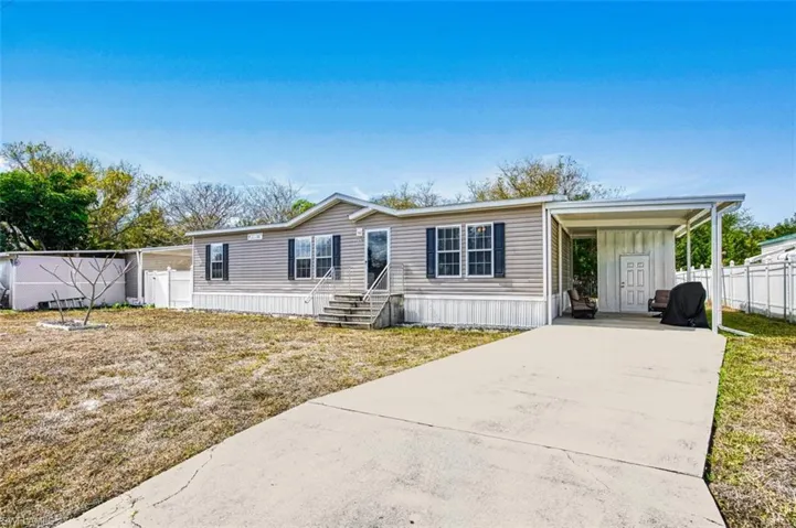 Manufactured / mobile home with an attached carport and driveway