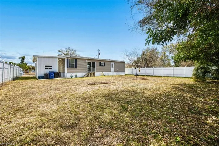 Rear view of property featuring a fenced backyard