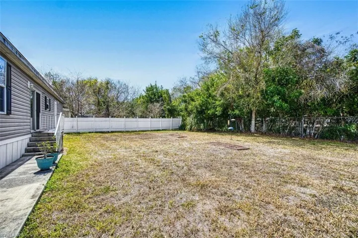 Fenced backyard with entry steps