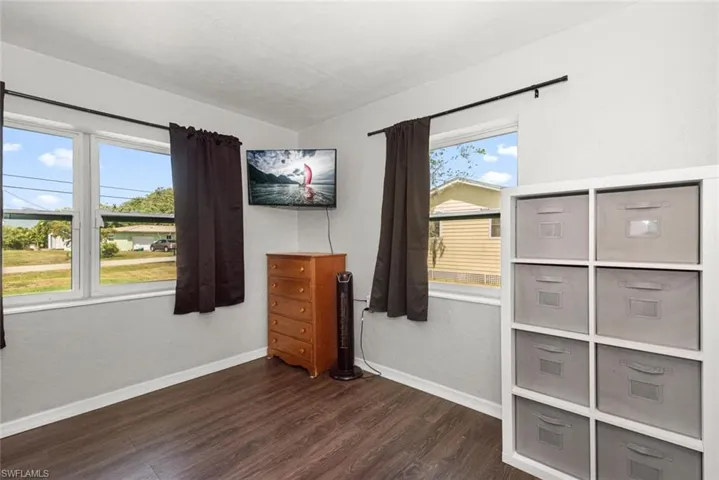 Bedroom featuring baseboards and dark wood finished floors