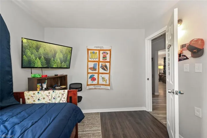Bedroom featuring baseboards and wood finished floors