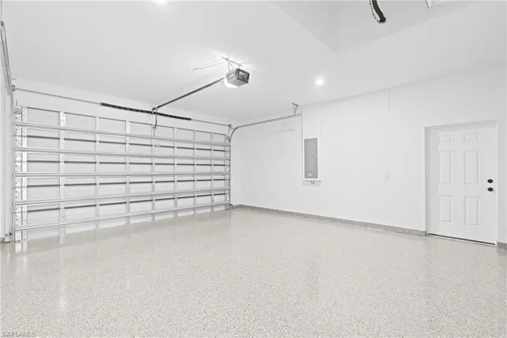 Garage with a garage door opener and electric panel