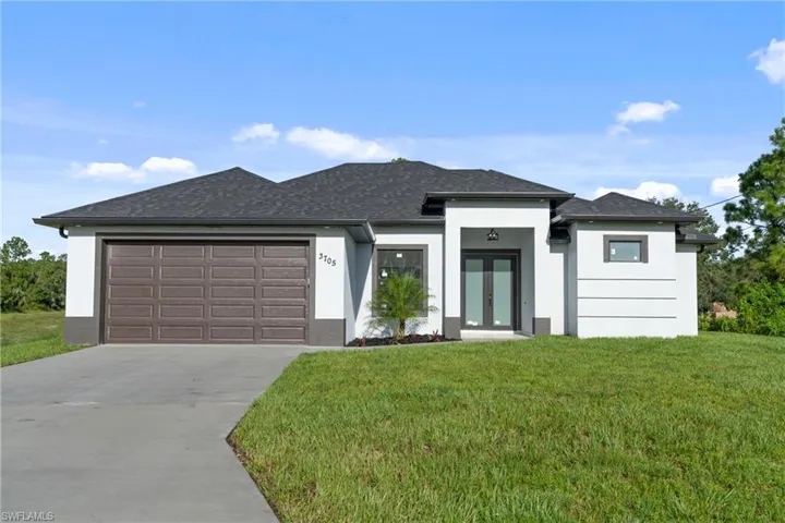 Prairie-style home featuring a garage and a front yard