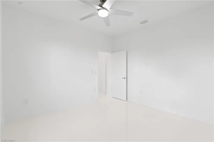 Spare room with tile patterned flooring and ceiling fan