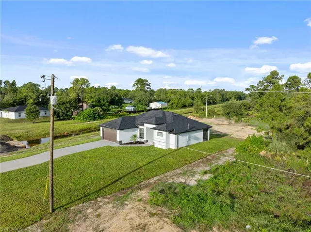 View of outdoor structure featuring a yard