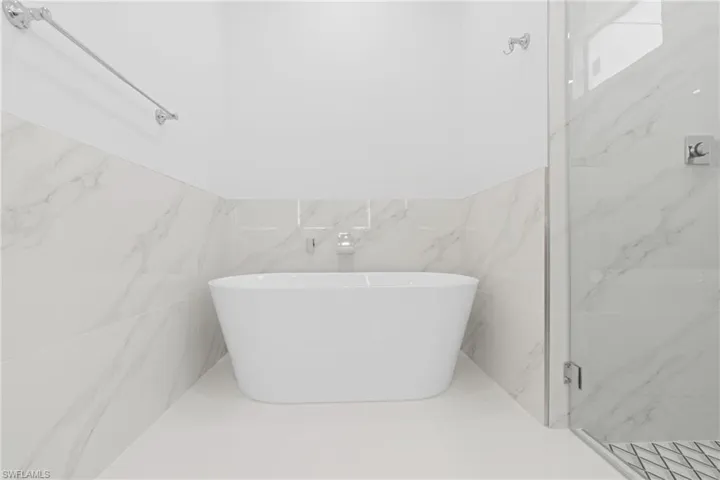 Bathroom with tile walls and tile patterned flooring