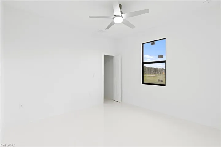 Spare room with ceiling fan