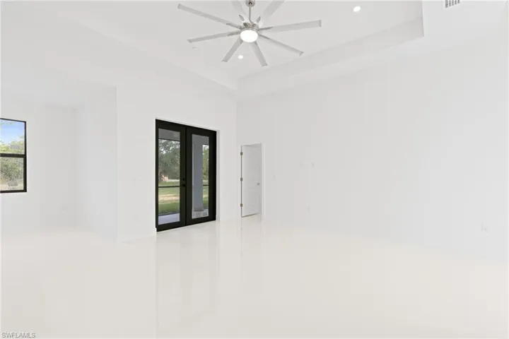 Unfurnished room featuring french doors and ceiling fan