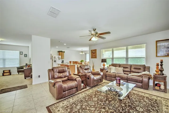 Tiled living room featuring ceiling fan