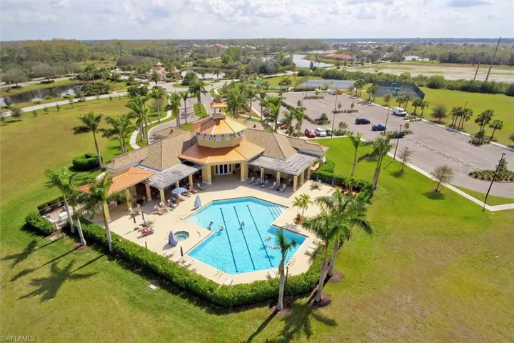 View of swimming pool with a patio and a lawn