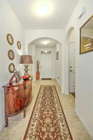 Hallway featuring light tile patterned flooring