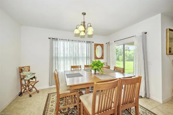 Tiled dining room with a notable chandelier