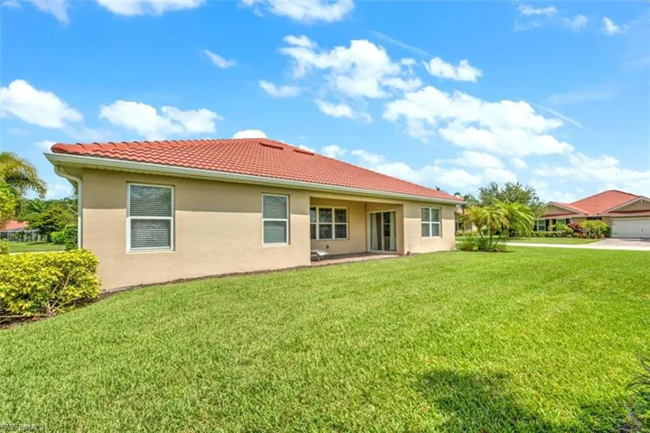 Back of house featuring a yard