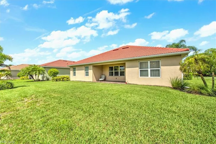 Back of house featuring a lawn