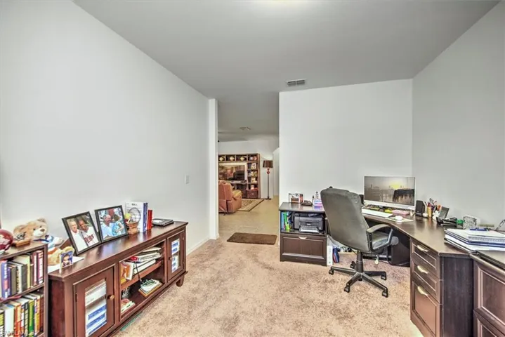 Home office with light carpet