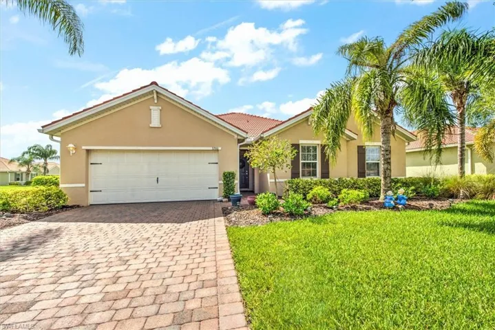 View of front of house featuring a garage and a front lawn