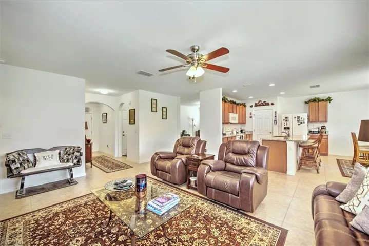 Living room featuring ceiling fan and light tile patterned floors