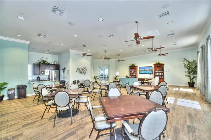 Dining space featuring crown molding, light wood-type flooring, and ceiling fan