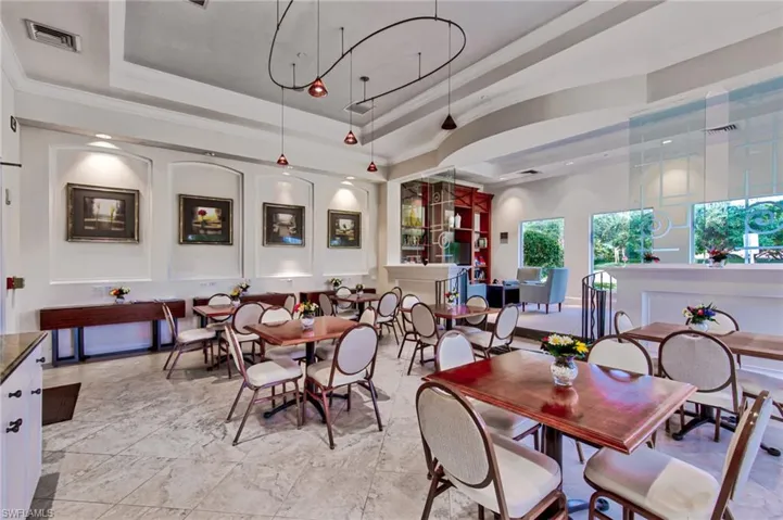 Dining area with a raised ceiling and light tile patterned floors