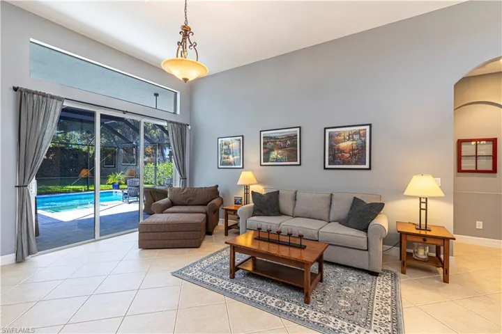 Tiled living room with a towering ceiling