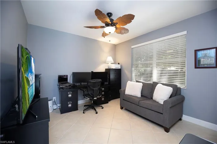 Office featuring light tile patterned floors and ceiling fan