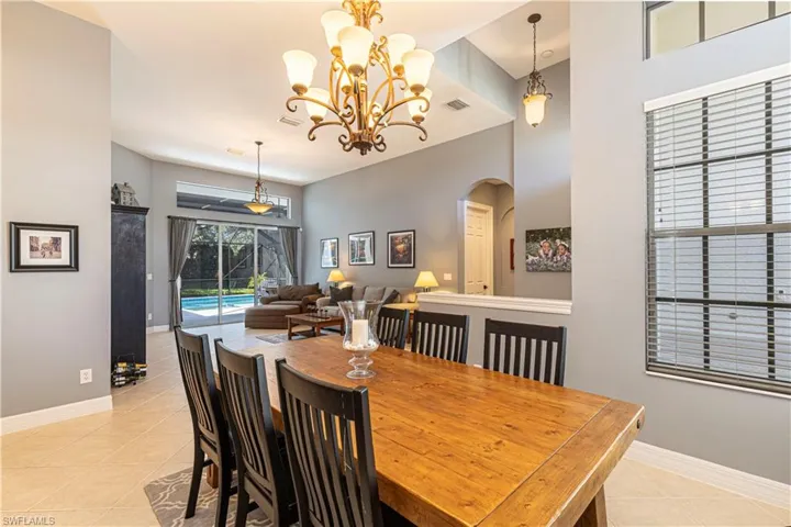 Tiled dining area with an inviting chandelier