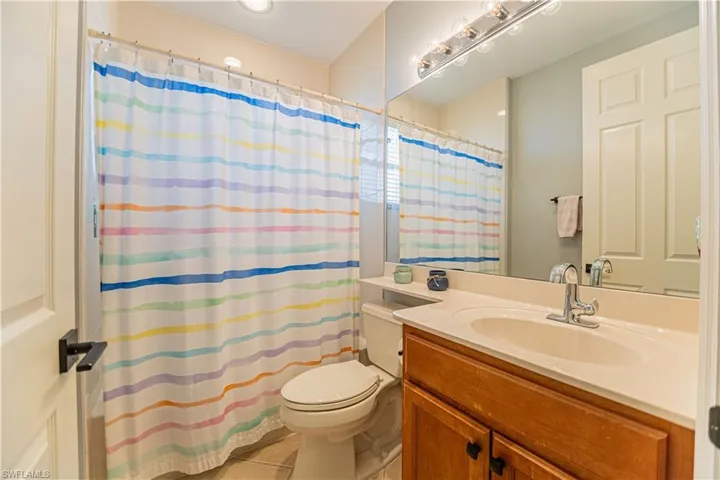 Bathroom featuring tile patterned floors, vanity, and toilet