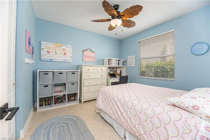 Tiled bedroom with ceiling fan