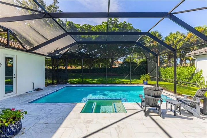 View of pool with a patio and a lanai