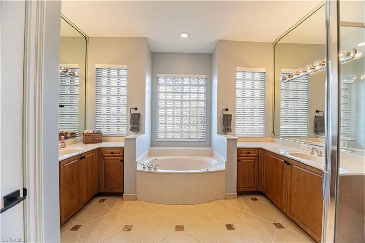 Bathroom with a tub, tile patterned floors, and vanity
