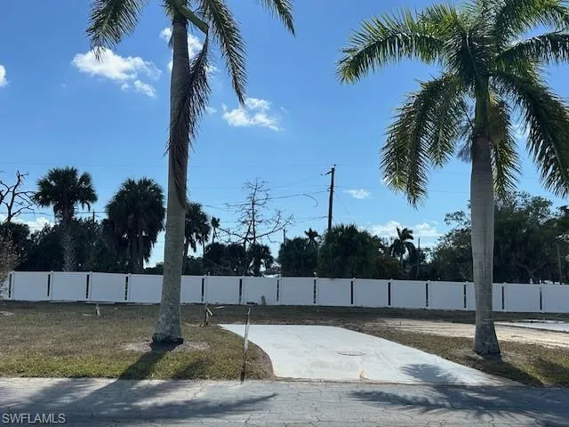White vinyl fence installed along the back for privacy