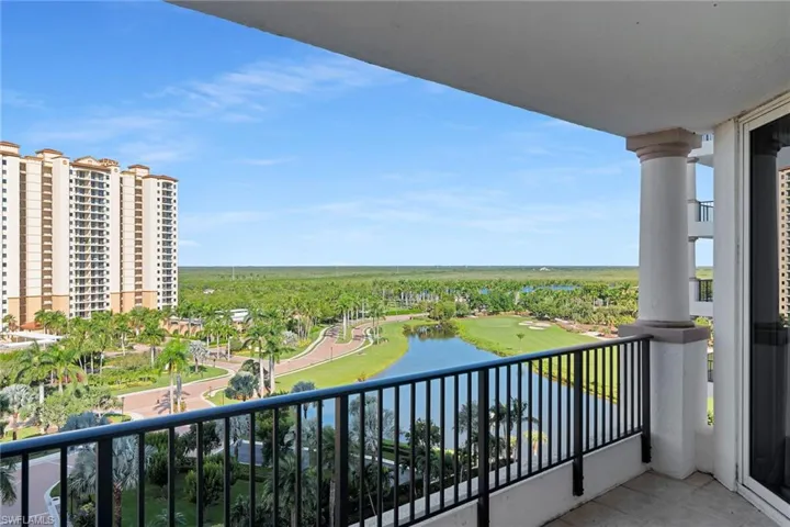 Balcony with a water view and golf course view