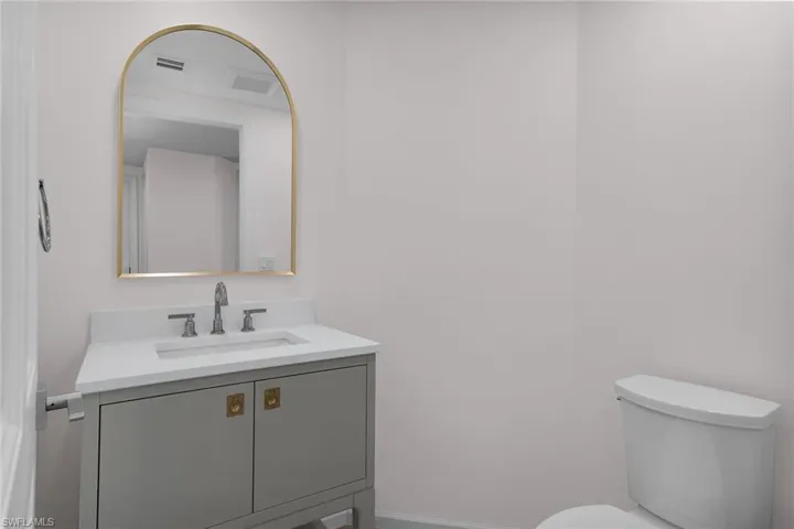 Bathroom featuring vanity and toilet