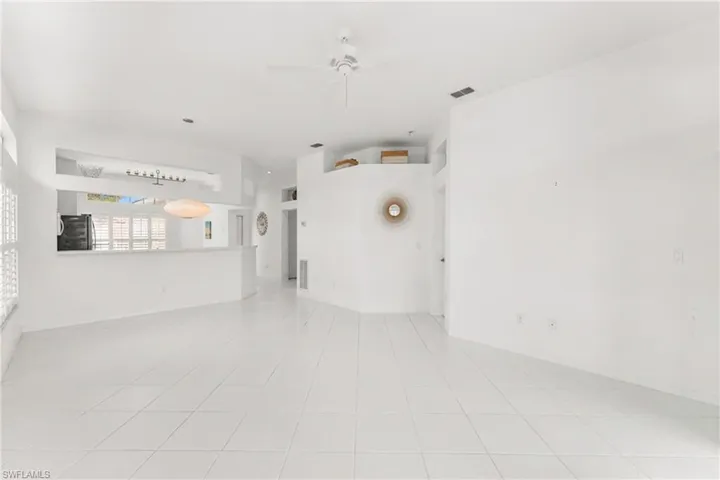 Unfurnished room featuring ceiling fan and light tile patterned flooring