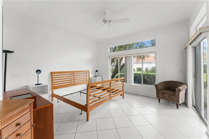 Bedroom featuring access to outside, a ceiling fan, and light tile patterned floors