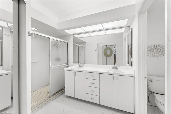 Bathroom with double vanity and a shower stall