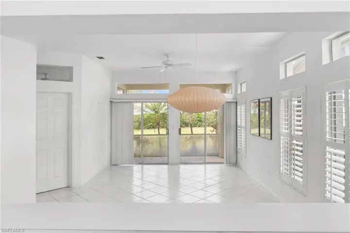 Spare room with a ceiling fan and light tile patterned floors