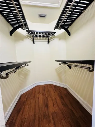 Spacious closet with hardwood / wood-style flooring