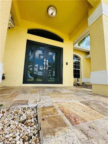 Property entrance featuring french doors